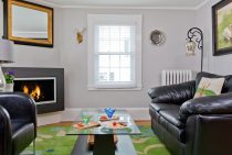 Living room with gas fireplace, couch, and leather chair
